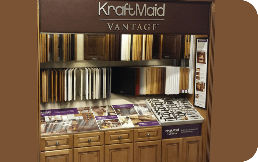 Display of kraftmaid vantage cabinets and finish samples at a home improvement store.