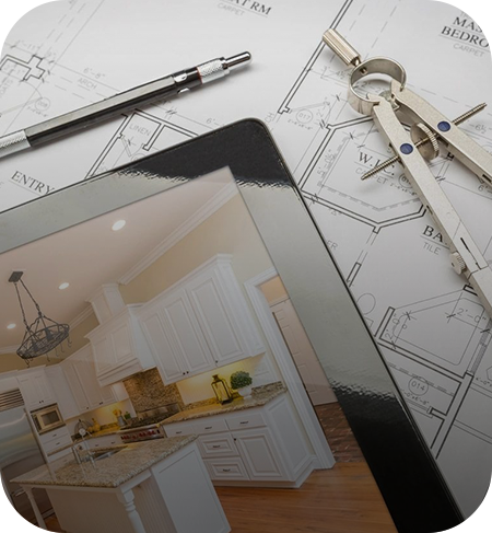 Architectural blueprints with a digital tablet displaying a kitchen design and a pair of compasses.